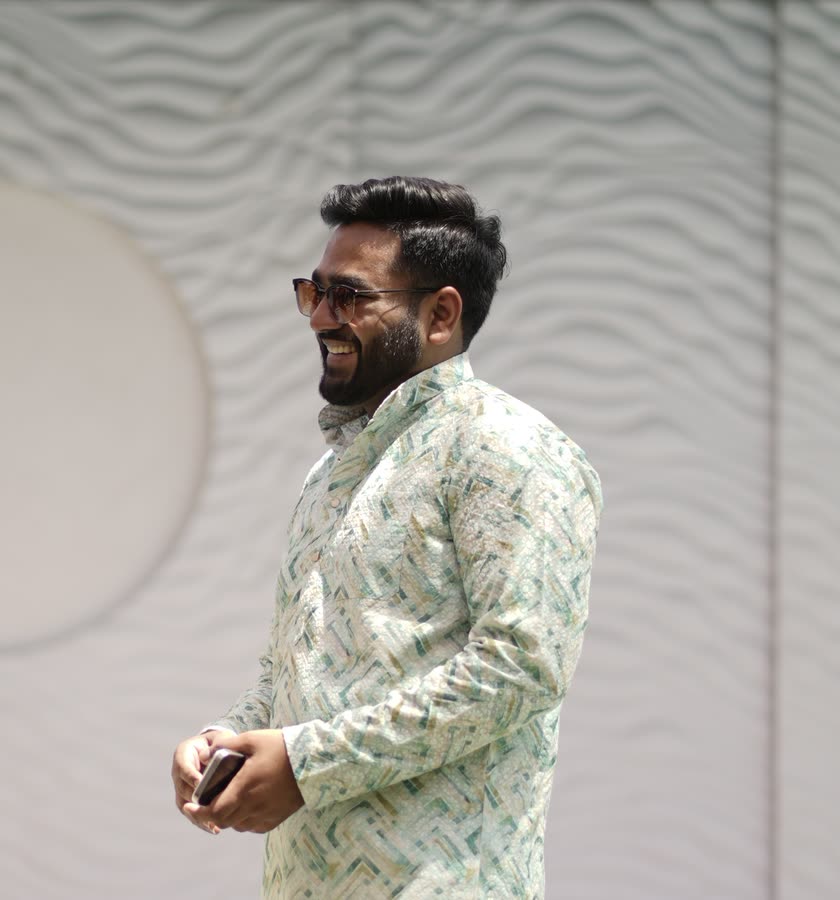 Harsh Agarwal smiling, wearing sunglasses and a patterned kurta